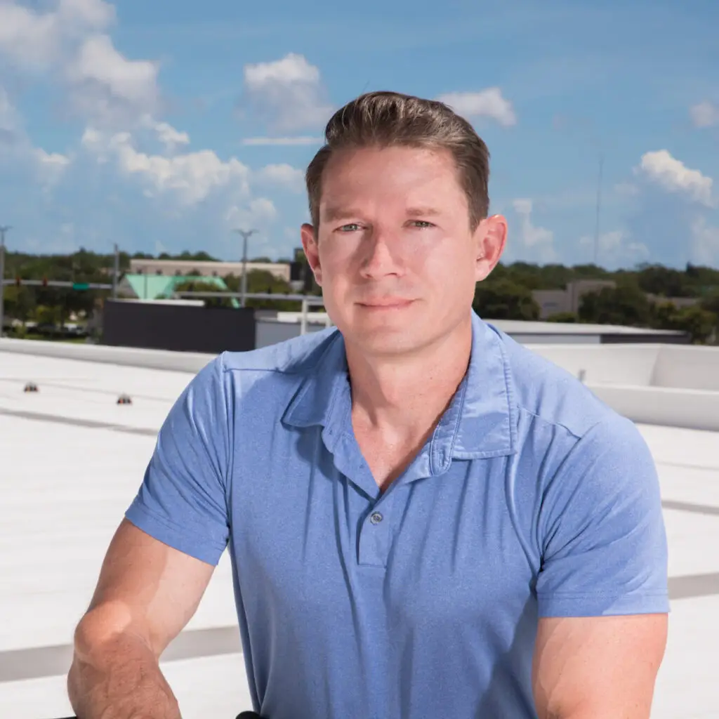 Corvex Roofing CEO standing on a white commercial roof at a Florida job site